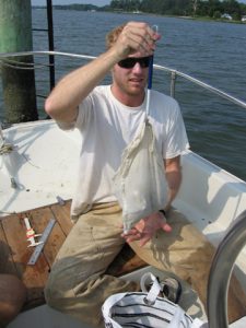 Andy Glass weighing an osprey chick