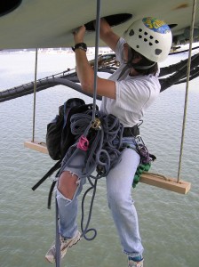 Elizabeth Long checks a peregrine nest as she hangs beneath the James River Bridg
