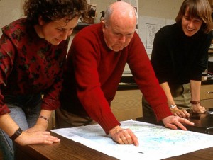 Mitchell Byrd examining a map of bald eagle nests with former graduate students