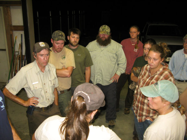 Woodpecker crew gathers around Kelly Morris around 2:30 AM to receive field assignments for placement of woodpeckers. Photo by Bryan Watts.