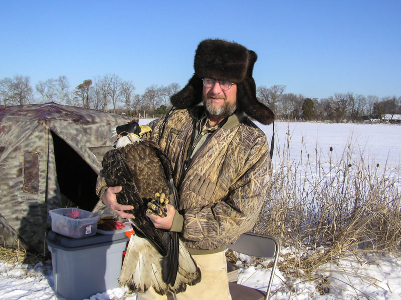 Briscoe White with bald eagle trapped on his property along the James River