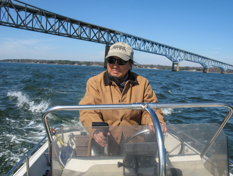 Marian piloting a boat on the Rappahannock River